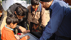 Researchers in the field with children